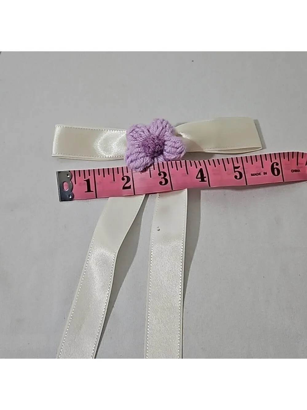 Hand Crafted Ivory Bow with Purple Crochet Flower